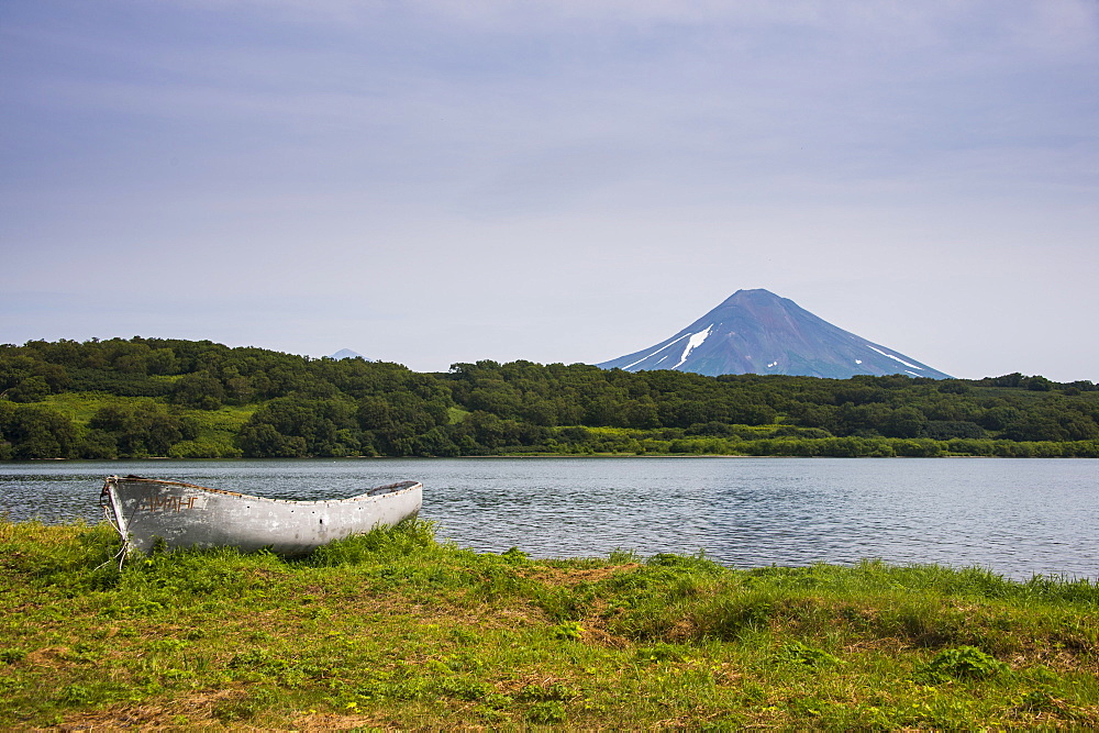 Wooden canoe in front of the Ilyinsky (volcano) and Kurile Lake, Kamchatka, Russia, Eurasia 