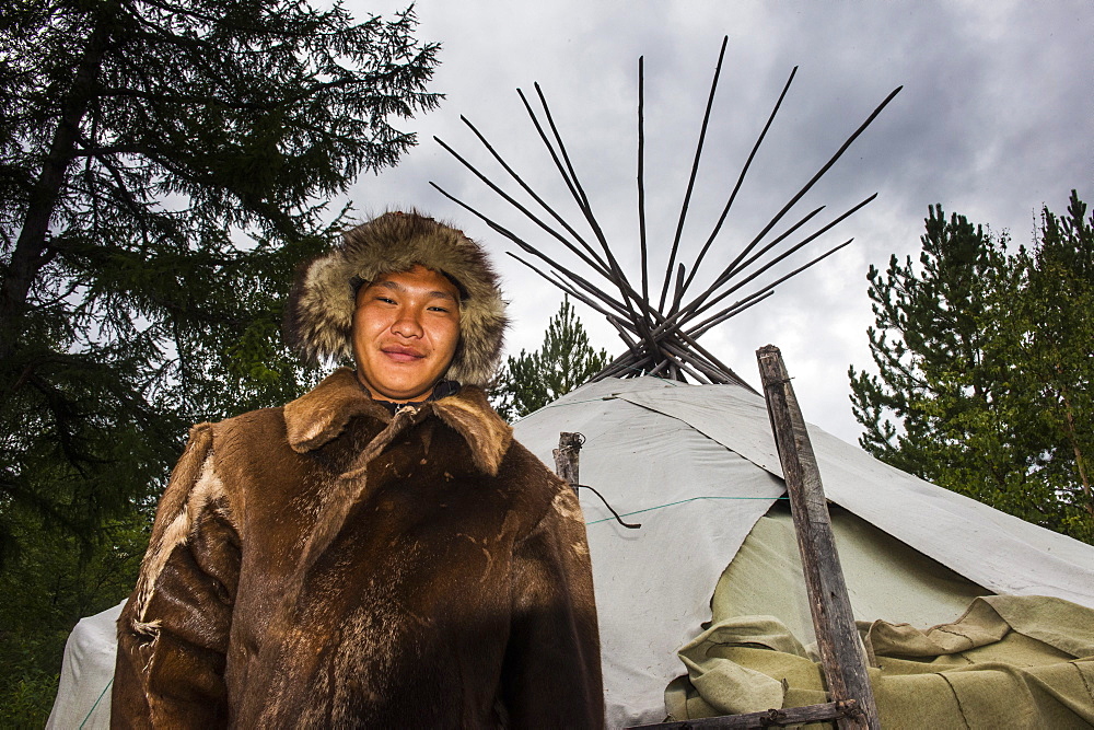 Koryak man, the native people of Kamchatka in front of a traditional tipi, Esso, Russia, Eurasia