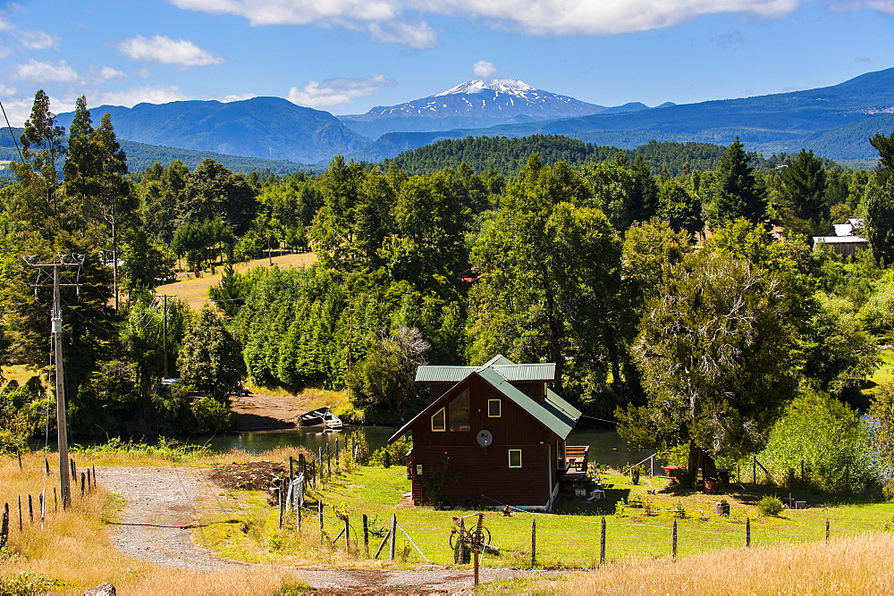 Farmhouse below the Volcano Villarrica and the beautiful landscape, Southern Chile, South America 