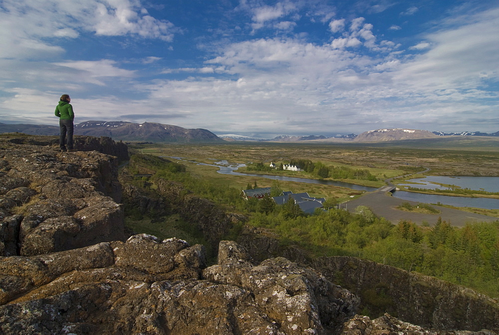 Woman looking at the vast bare landscape of Pingvellir, where the American and European shelves divide, Iceland, Polar Regions