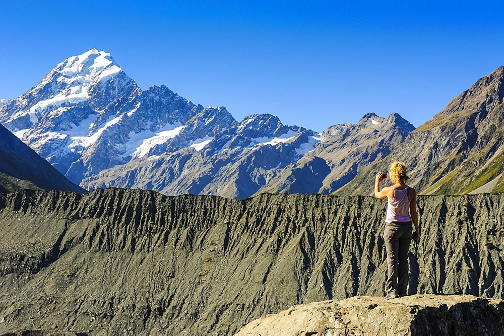 Woman photographing Mount Cook, South Island, New Zealand