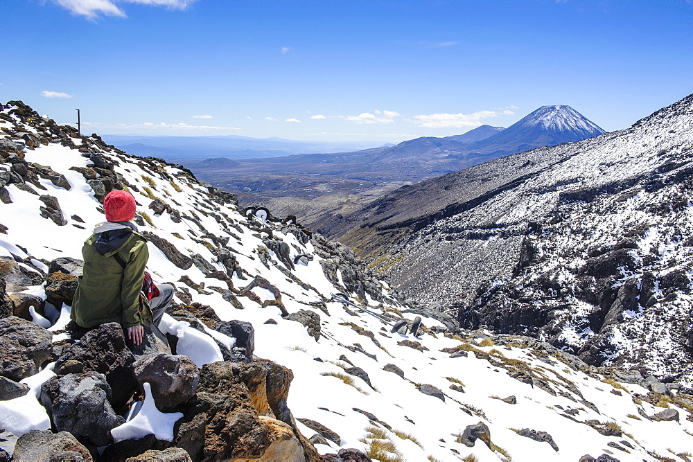 Woman on Mount Ruapehu looking towards Mount Ngauruhoe, Tongariro National Park, UNESCO World Heritage Site, North Island, New Zealand, Pacific