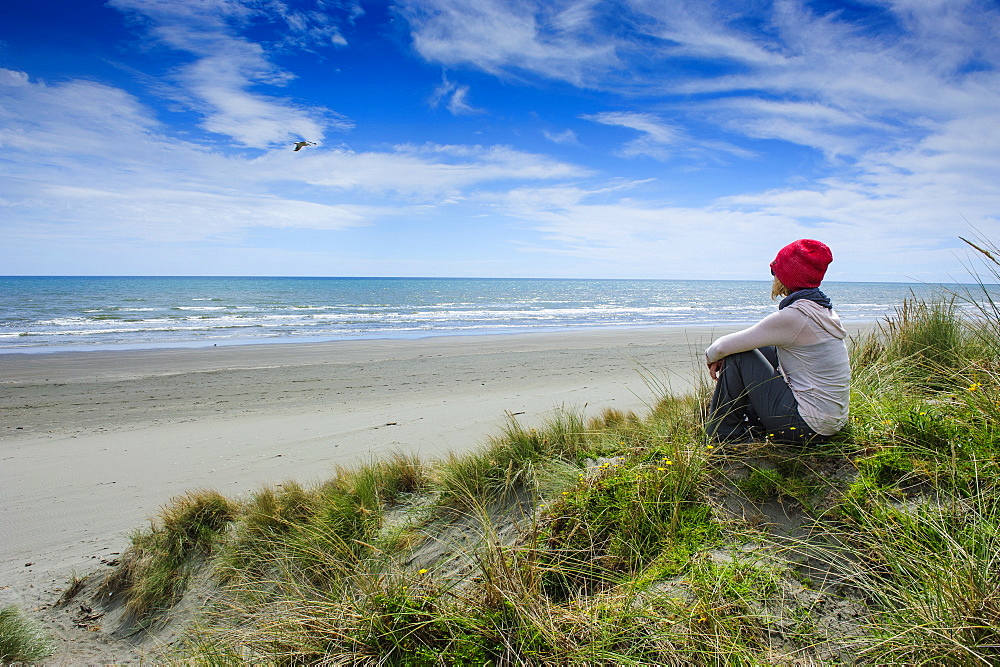 Woman enjoying the view over Foxton beach, Kapiti Coast, North Island, New Zealand, Pacific