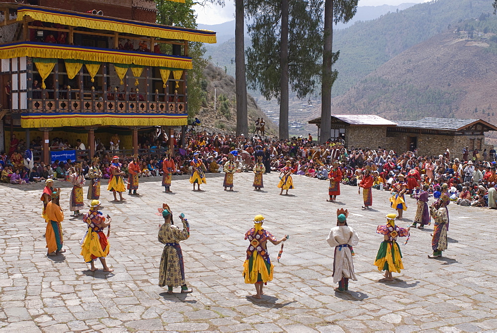 Costumed dancers at religious festival with many visitors, Paro Tsechu, Paro, Bhutan, Asia