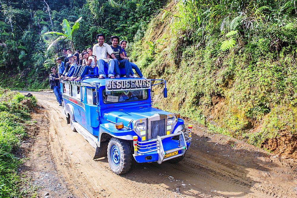 People sitting on a the roof of a jeepney driving through the Hapao rice terraces, Banaue, UNESCO World Heritage Site, Luzon, Philippines, Southeast Asia, Asia