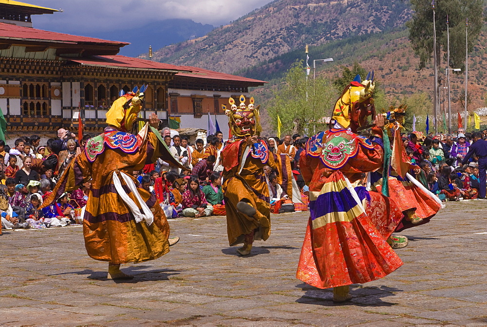 Costumed dancers at religious festival with many visitors, Paro Tsechu, Paro, Bhutan, Asia