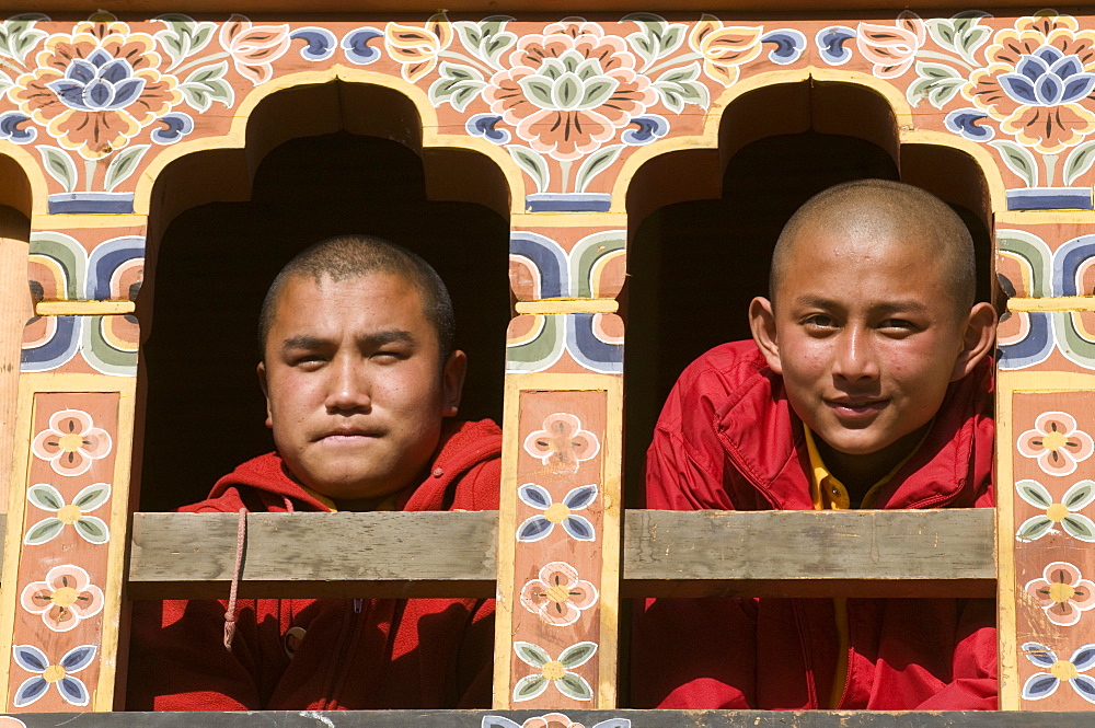 Young Buddhist monks at window, Gangte Goempa, Bhutan, Asia