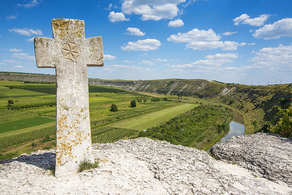 Old Christian cross above the historical temple complex of old Orhei (Orheiul Vechi), Moldova, Europe