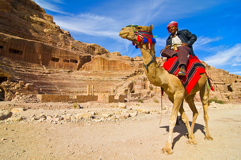 Bedouin on a camel in front of the amphitheater of Petra, UNESCO World Heritage Site, Jordan, Middle East