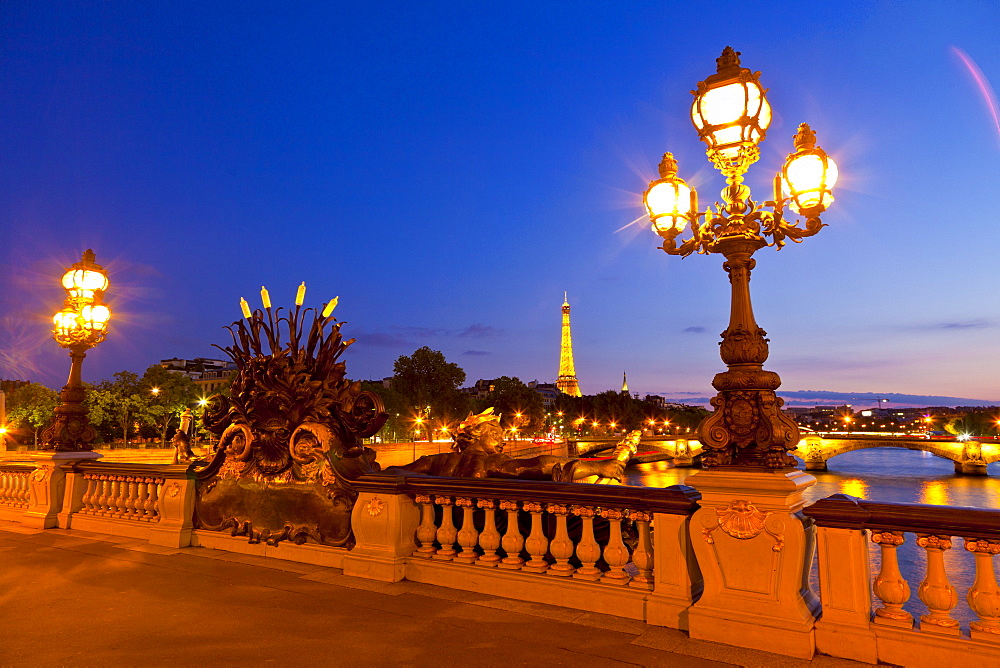 Eiffel Tower as seen from the Pont Alexandre III (Alexander III Bridge) at night, Paris, France, Europe