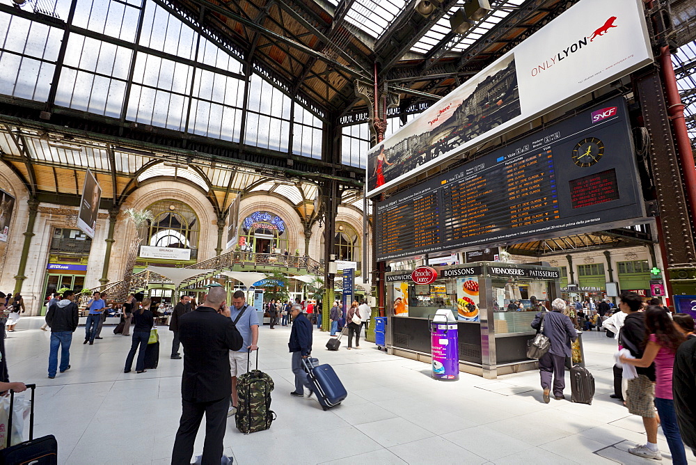 Passengers traversing through train station, by the arrival/departure board, Gare de Lyon train station, Paris, France, Europe