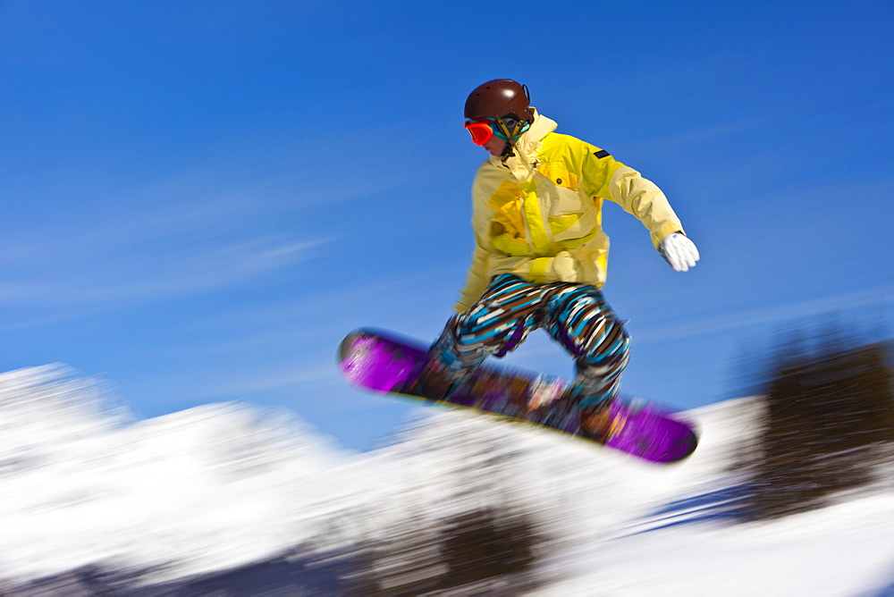 Snowboarder flying off a ramp, Whistler Mountain, Whistler Blackcomb Ski Resort, Whistler, British Columbia, Canada, North America