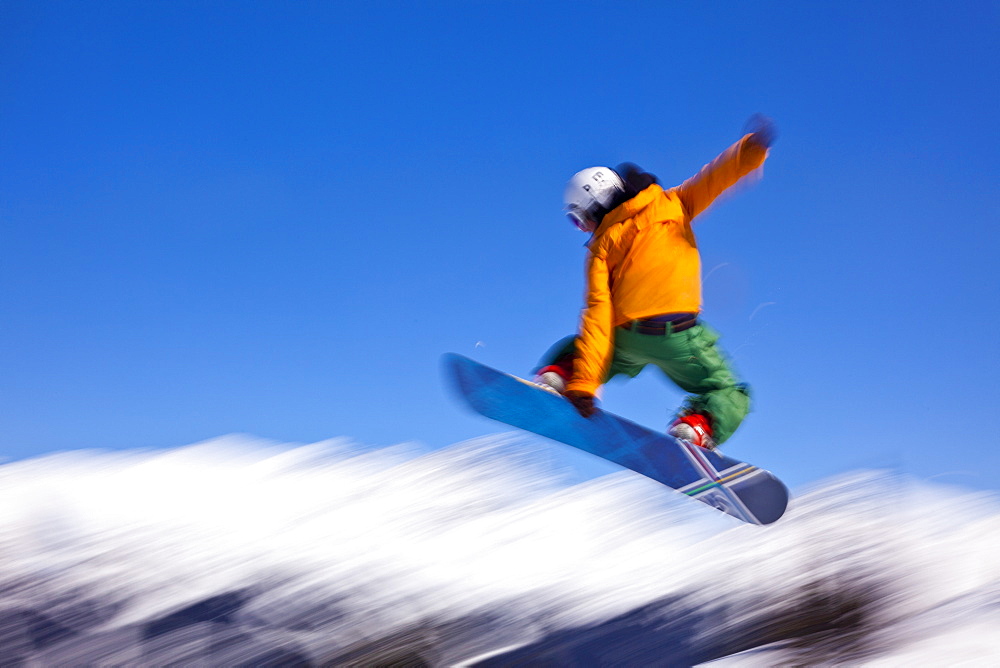 Snowboarder flying off a ramp, Whistler Mountain, Whistler Blackcomb Ski Resort, Whistler, British Columbia, Canada, North America