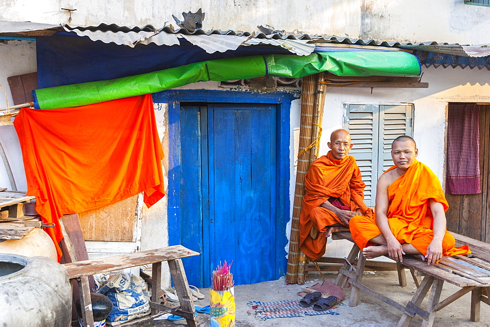 Buddhist monks by blue door, Phnom Penh, Cambodia, Indochina, Southeast Asia, Asia