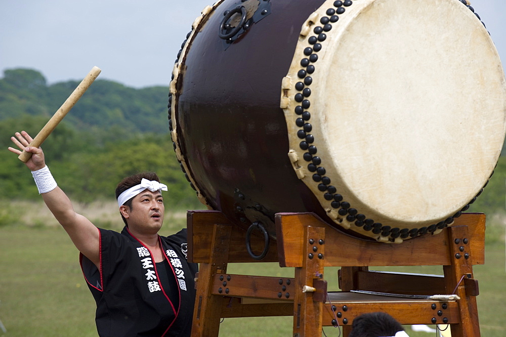 Drummer performing on a Japanese taiko drum at a festival in Kanagawa, Japan, Asia