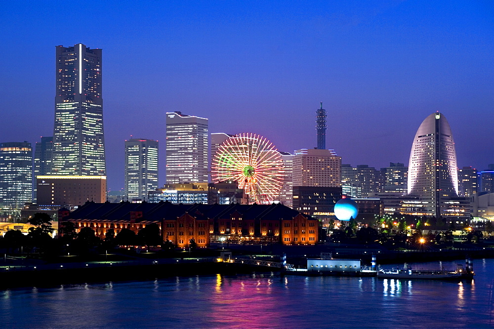 Twilight view of Red Brick Park and Landmark Tower at MM21 waterfront complex, Yokohama, Japan, Asia