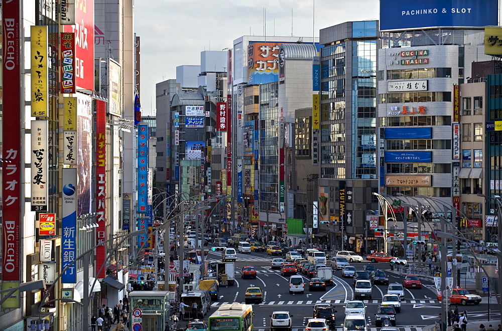 Tall buildings, signs and traffic create the urban canyon of Chuo-dori Street in the Ueno district of Tokyo, Japan, Asia