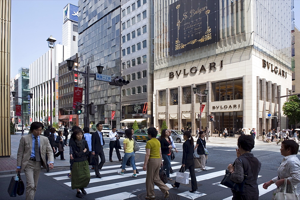 Shoppers strolling along Chuo-dori Street in the affluent Ginza retail and entertainment district in Tokyo, Japan, Asia