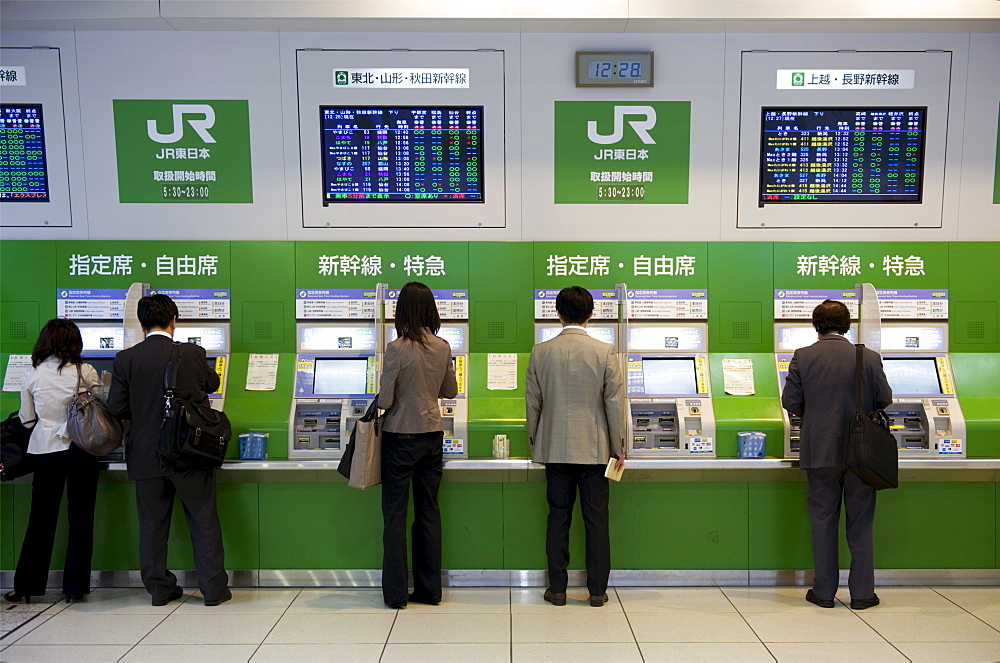 Passengers purchasing bullet train tickets from vending machines at the central JR (Japan Railway) station in Tokyo, Japan, Asia