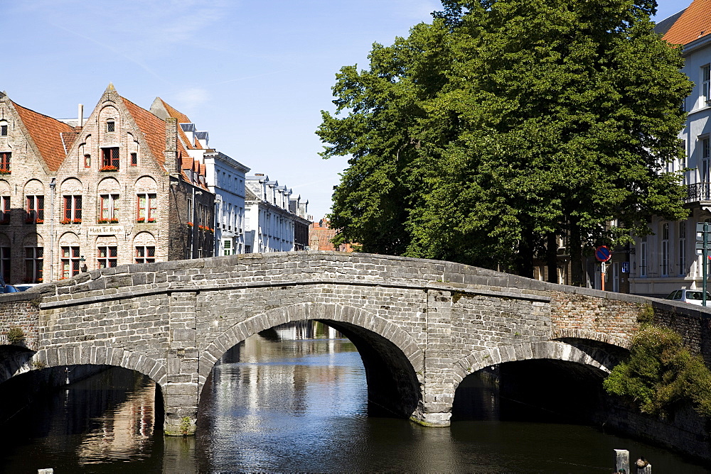 Stone bridge over canal with medieval buildings in background, Bruges, Belgium, Europe