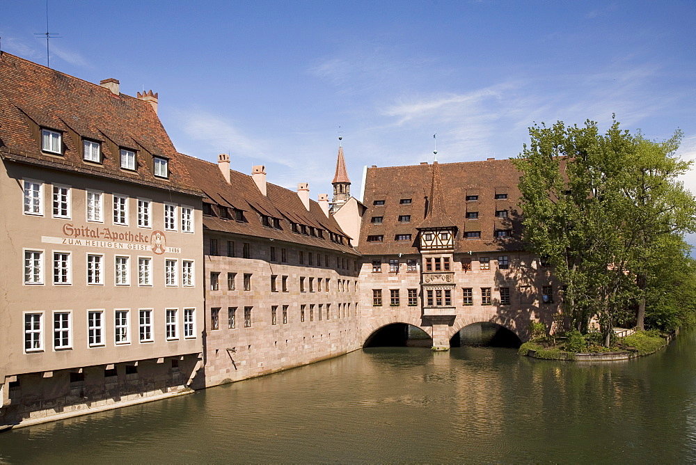 The Holy Ghost Hospital (Heilig-Geist-Spital), one of Europe's largest medieval hospitals, by the river Pegnitz in Nuremberg, Bavaria, Germany, Europe