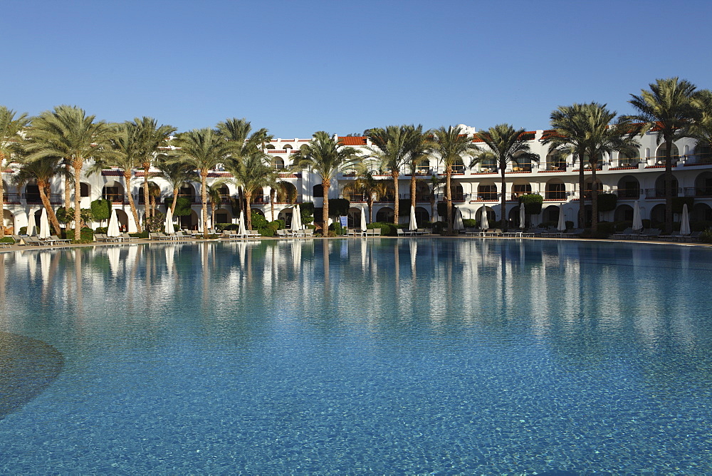 Rooms with verandas overlook a palm fringed swimming pool within the Royal Savoy Resort at Sharm el-Sheikh, Egypt, North Africa, Africa