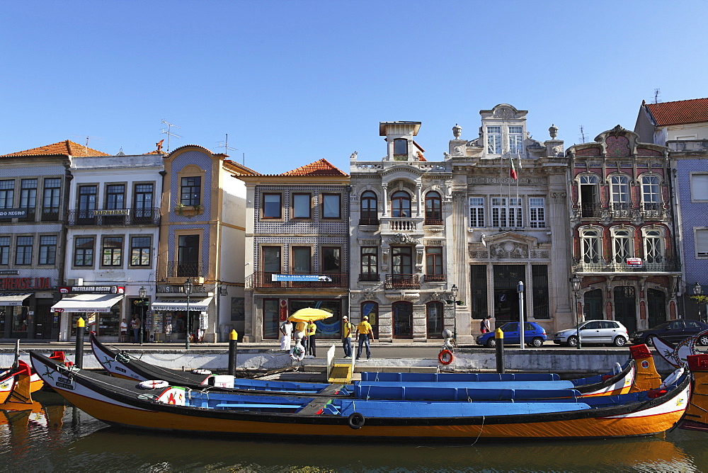 Moliceiro boats docked by Art Nouveau style buildings along the Central Canal, Aveiro, Beira Litoral, Portugal, Europe