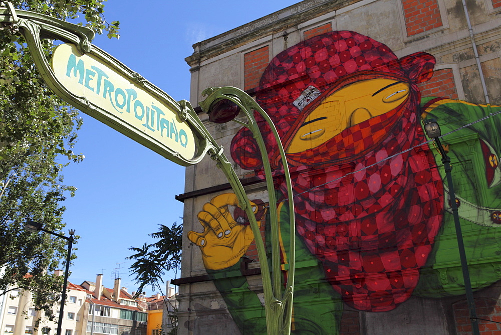 The Art Nouveau Metropolitano sign at Picoas and Gemeo's facade, part of the Crono urban art project, Lisbon, Portugal, Europe