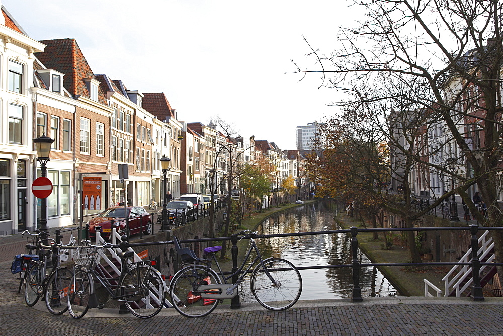 Looking along the Catharijnsingel, bicycles stand on a bridge over a canal in Utrecht, Utrecht Province, Netherlands, Europe