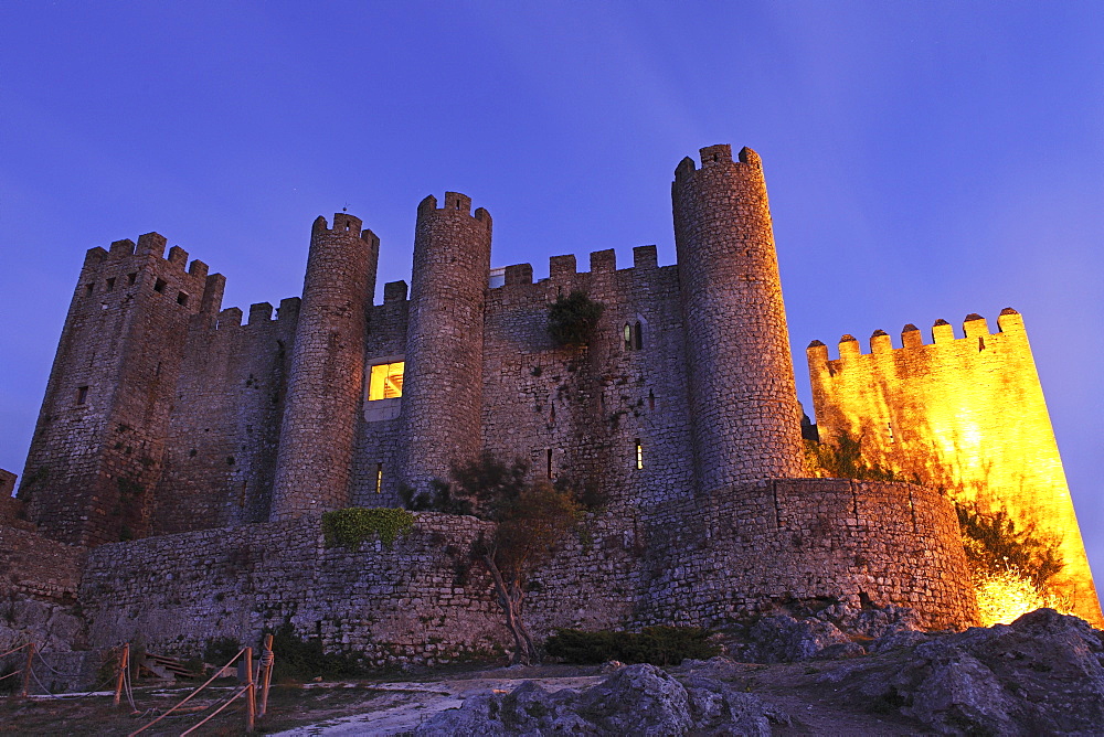 Obidos castle, today used as a luxury Pousada hotel, partially illuminated at night, Obidos, Estremadura, Portugal, Europe