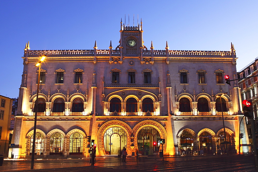 The Neo-Manueline facade of Rossio railway station, at night, in the Baixa district of Lisbon, Portugal, Europe