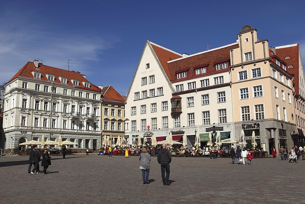 Town Hall Square, surrounded by grand, historic buildings, many now used as bars and cafes, in Tallinn, Estonia, Europe