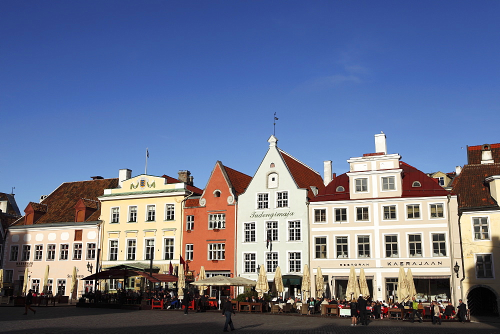 Town Hall Square, surrounded by grand, historic buildings, many now used as bars and cafes, in Tallinn, Estonia, Europe