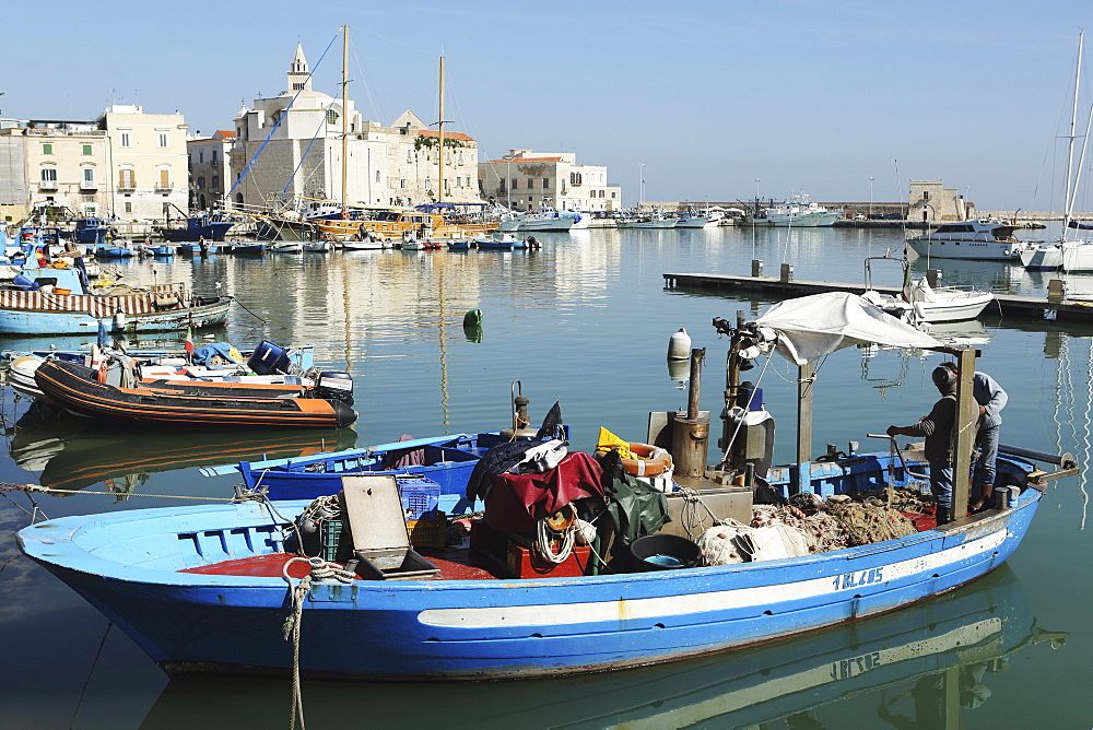 A fishing boat in the harbour by the cathedral of St. Nicholas the Pilgrim (San Nicola Pellegrino) in Trani, Apulia, Italy, Europe