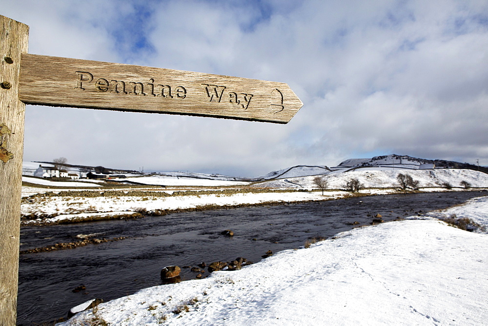 Sign for the Pennine Way walking trail on snowy landscape by the River Tees, Upper Teesdale, County Durham, England, United Kingdom, Europe