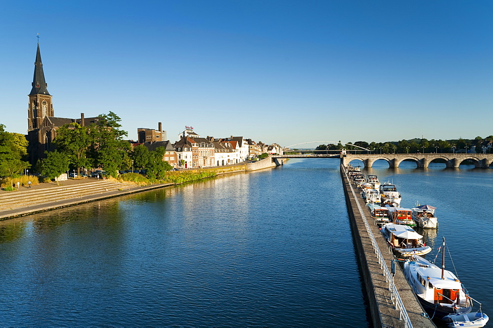 St. Maartenskerk (St. Martin Church) and St. Servatius Bridge wharf on the River Maas, Maastricht, Limburg, The Netherlands, Europe