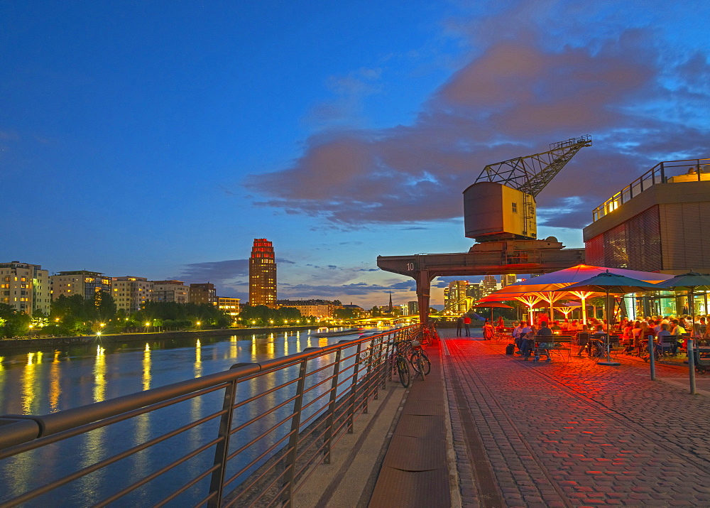 Restaurant beneath old dockyard crane by River Main, Frankfurt-am-Main, Hesse, Germany, Europe