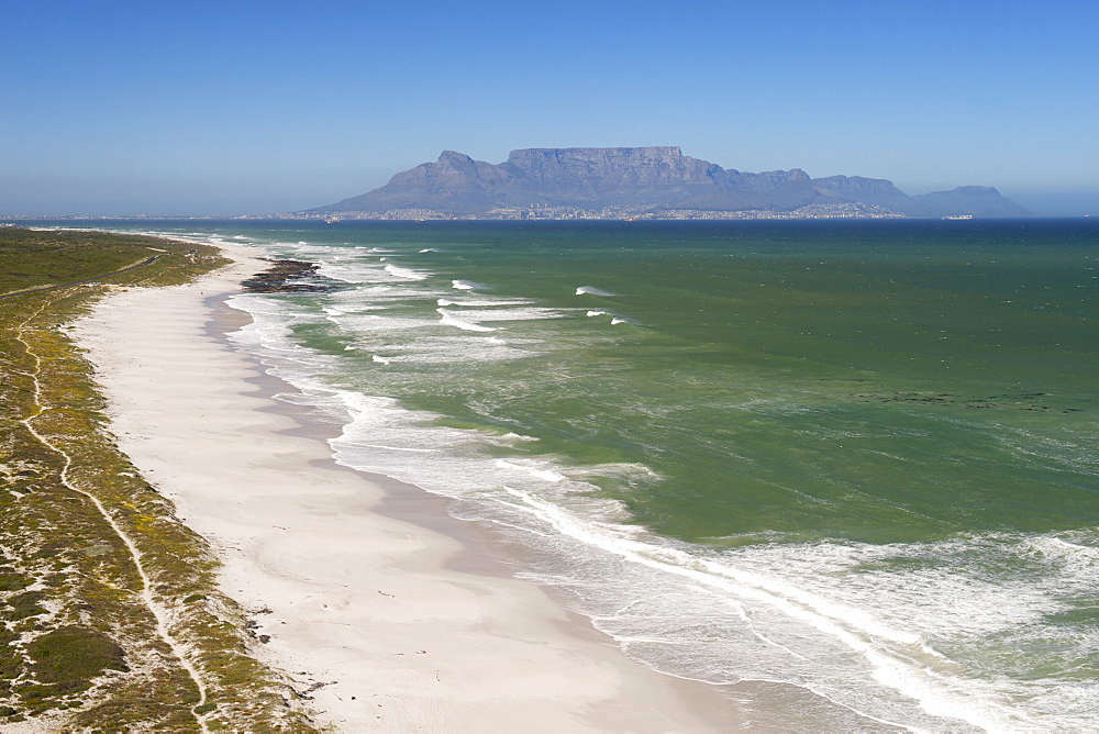 Aerial view along the coastline and beach of the Blaauwberg Nature Reserve on the west coast, north of Cape Town  with Table Mountain in distance across Table Bay, South Africa, Africa