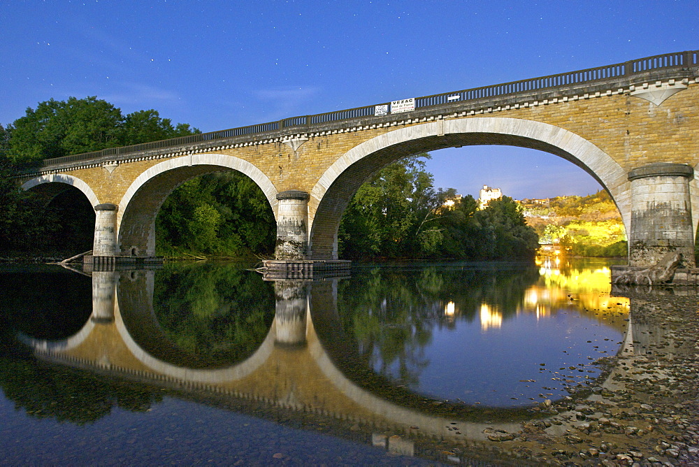 Night-time, moonlit view of an old bridge over the Dordogne River near Beynac, Dordogne region, France, Europe