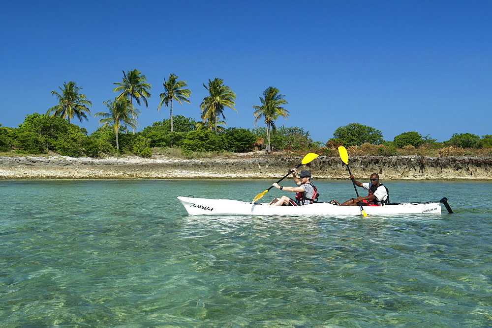 Two men kayaking off Mogundula island in the Quirimbas archipelago in northern Mozambique, Indian Ocean, Africa