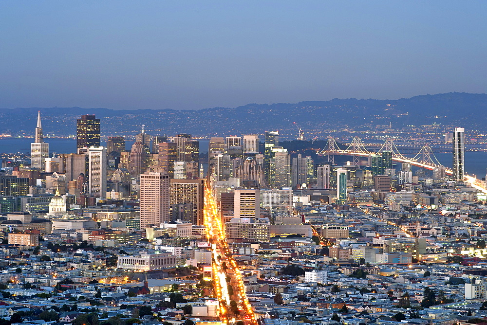 Dusk view of San Francisco, Market Street and the Oakland Bay Bridge from the summit of Twin Peaks, San Francisco, California, United States of America, North America