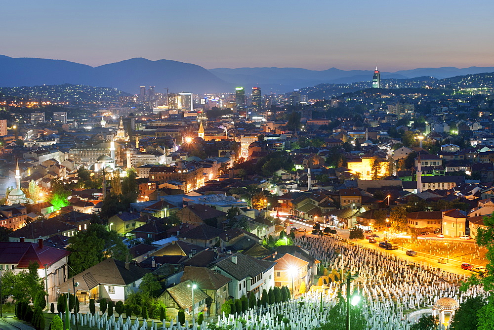 Dusk view of Sarajevo, with the Martyrs Memorial Cemetery, Kovaci, in the foreground, Sarajevo, Bosnia and Herzegovina, Europe