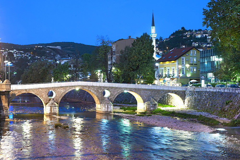 Dusk view of the Latin Bridge, a historic Ottoman bridge over the Miljacka River in Sarajevo, capital of Bosnia and Herzegovina, Europe