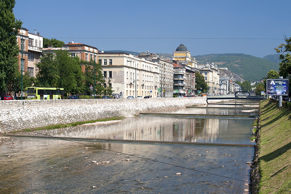 Buildings along Obala Kulina Bana road on the north bank of the Miljacka River in Sarajevo, capital of Bosnia and Herzegovina, Europe