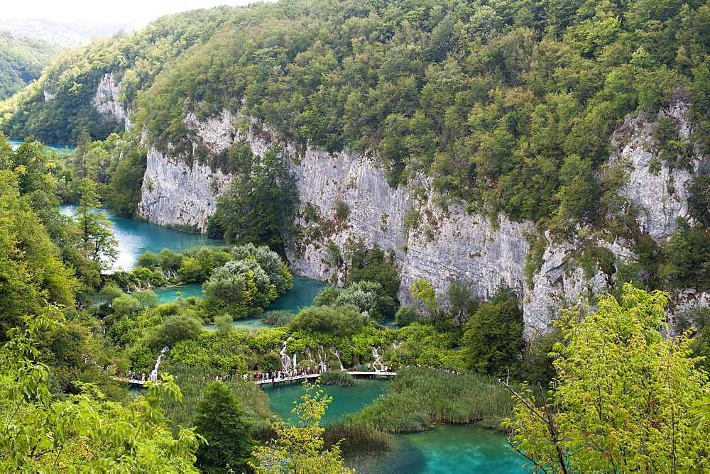 Tourists walking along wooden walkways in Plitvice Lakes National Park, UNESCO World Heritage Site, Croatia, Europe