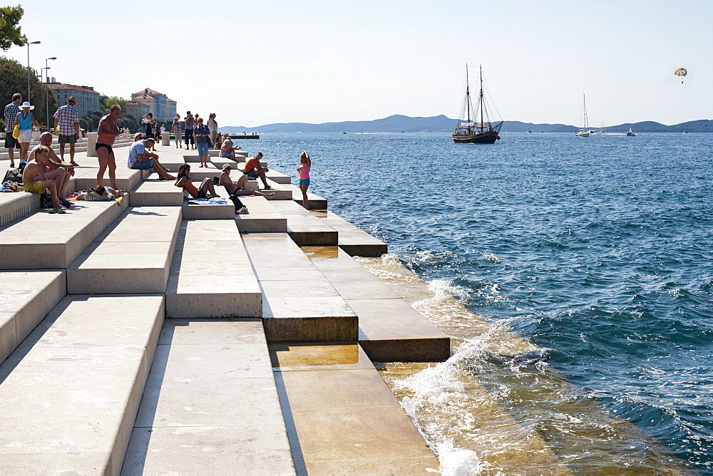 People on the steps of the Sea Organ in Zadar on the Adriatic coast, Croatia, Europe