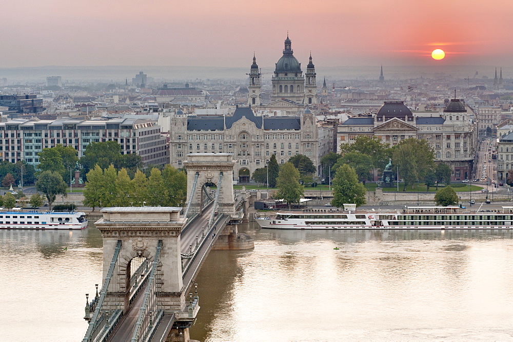 Sunrise over city with the Szechenyi Chain Bridge and the dome of St. Stephen's Basilica, Budapest, Hungary, Europe