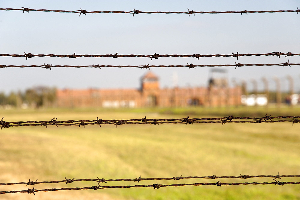 Barbed-wire fencing and buildings at the museum of the former Auschwitz II-Birkenau concentration camp, UNESCO World Heritage Site, southern Poland, Europe