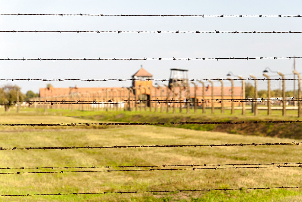 Barbed-wire fencing and buildings at the museum of the former Auschwitz II-Birkenau concentration camp, UNESCO World Heritage Site, Poland, Europe