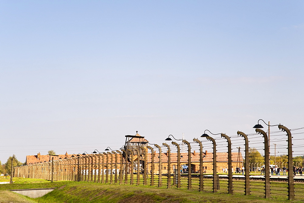 Electrified barbed-wire fencing and buildings at the museum of the former Auschwitz II-Birkenau concentration camp, UNESCO World Heritage Site, Poland, Europe